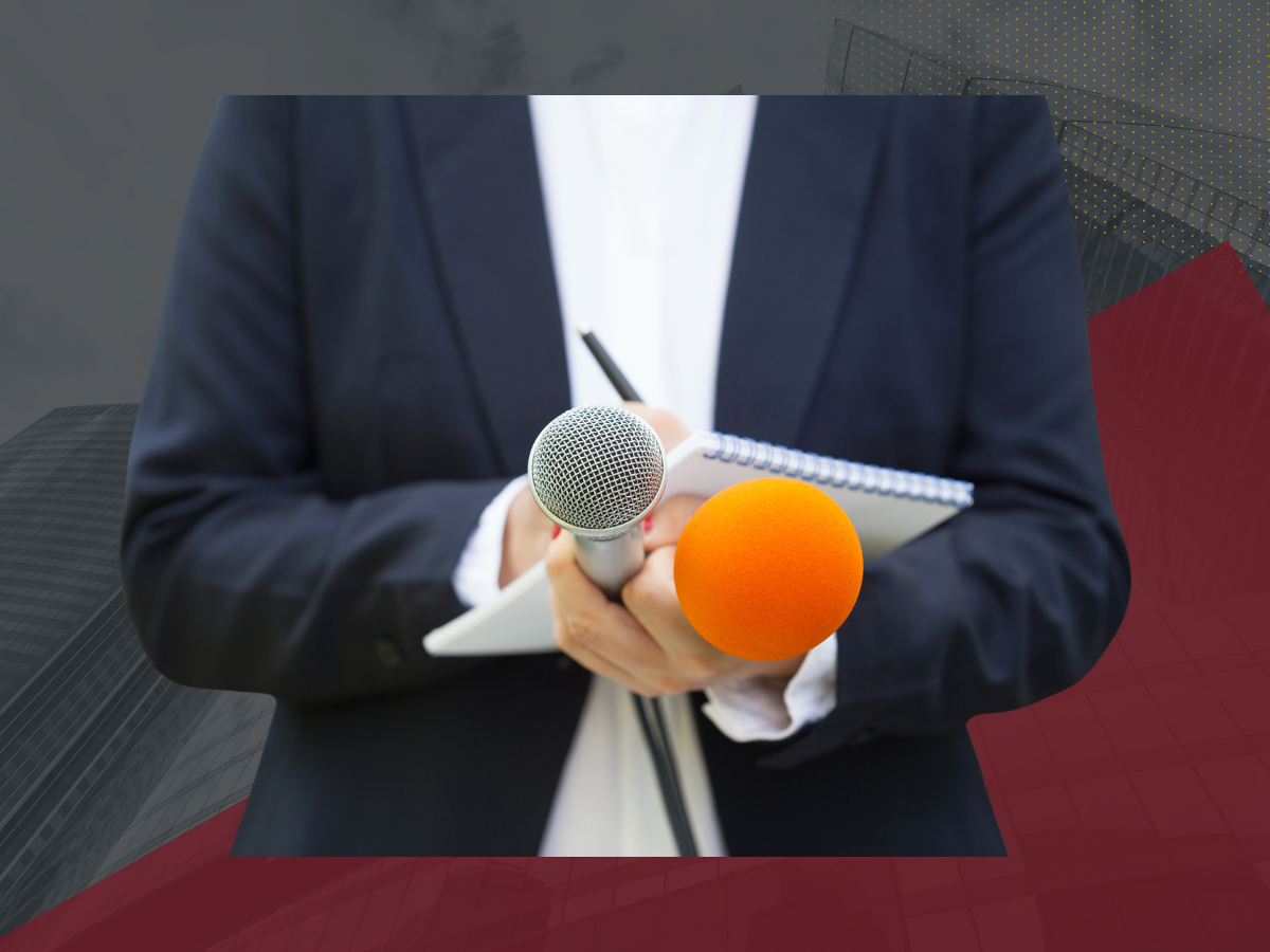 Reporter holding notepad and two microphones