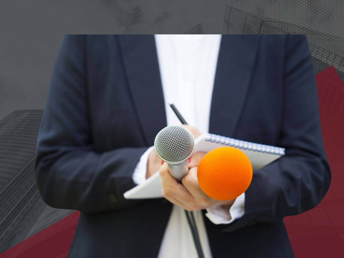 Reporter holding notepad and two microphones